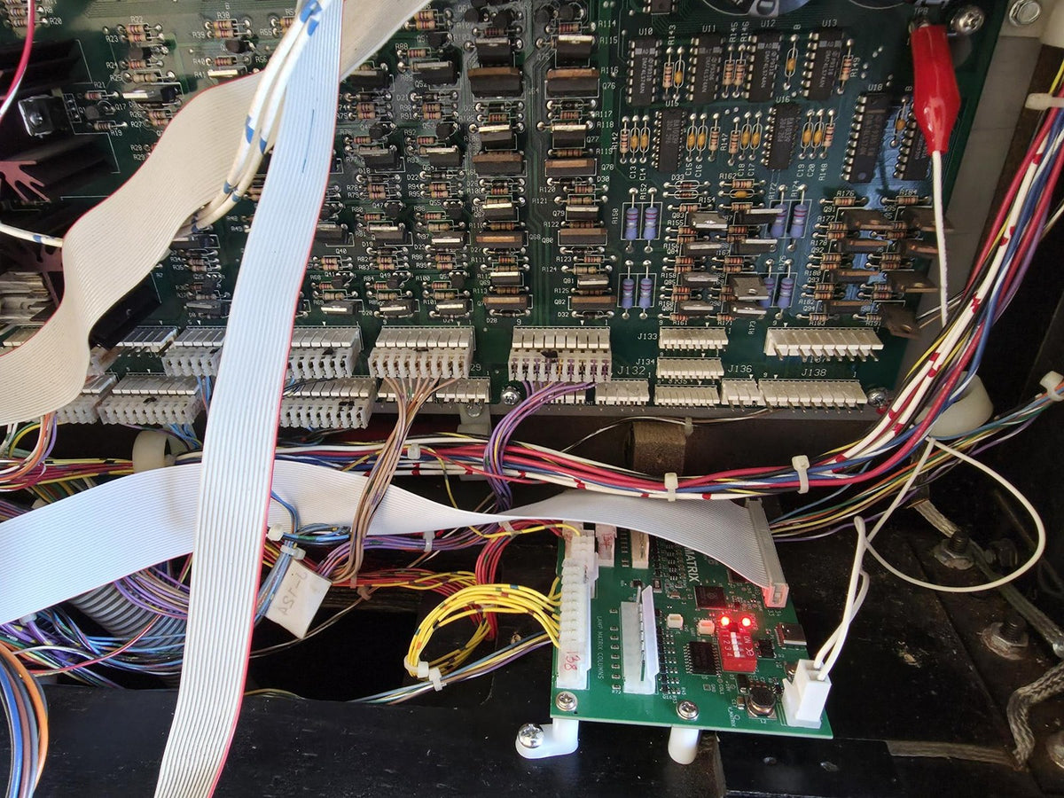 Aurora Matrix fitted below the power driver board in a WPC pinball machine backbox